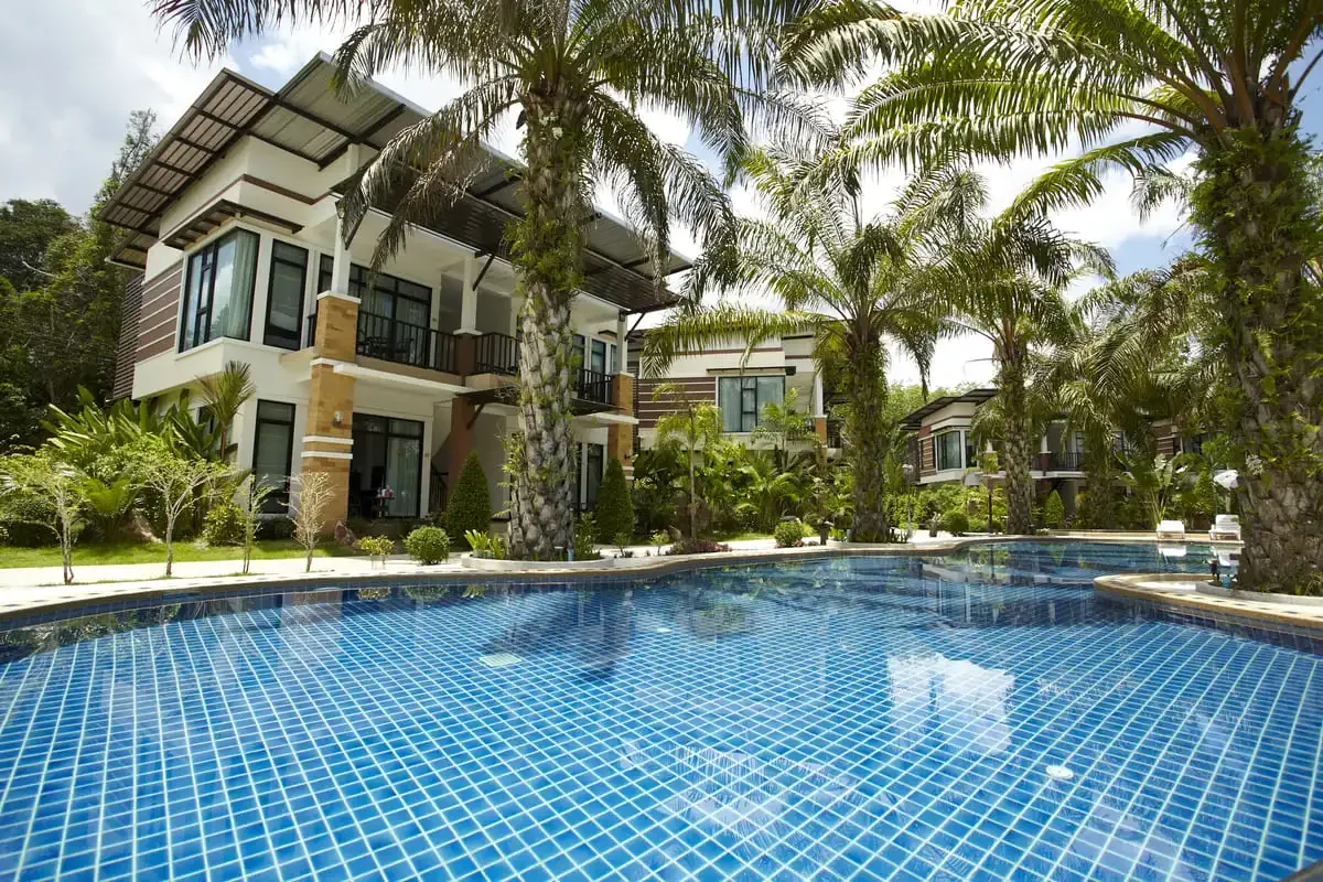 Tropical resort with swimming pool and palm trees in Krabi, Thailand.