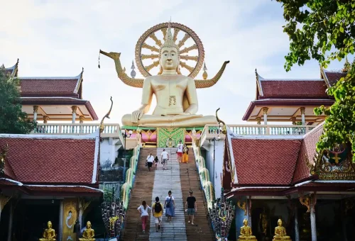 Tourists walking up the stairs to the famous Big Buddha Temple on Koh Samui.