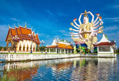 Wat Plai Laem Temple with the Guanyin statue and lake reflection in Koh Samui, Thailand.