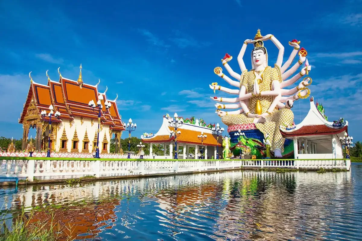 Wat Plai Laem Temple with the Guanyin statue and lake reflection in Koh Samui, Thailand.