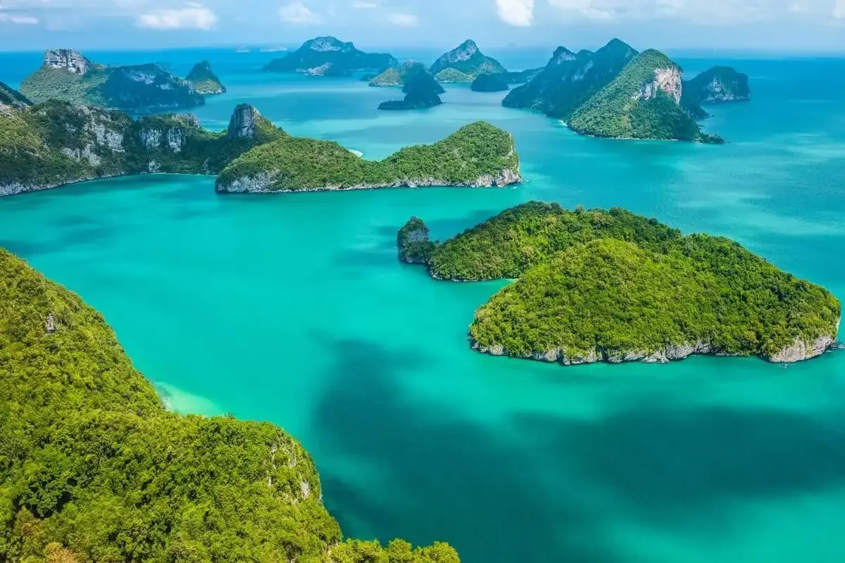 Aerial view of Koh Ang Thong National Marine Park with emerald lagoons, limestone cliffs, and tropical islands in the Gulf of Thailand.