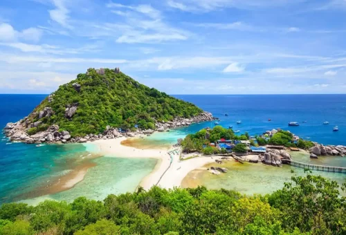Aerial view of Koh Nangyuan showing its sandbar connecting three lush green islands in the Gulf of Thailand.
