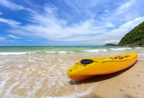 Yellow kayak on the sandy beach of Angthong Marine Park surrounded by calm turquoise sea.