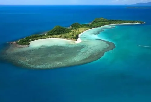 Aerial view of Coral Island near Samui, showing turquoise lagoons and lush greenery surrounded by the Gulf of Thailand.