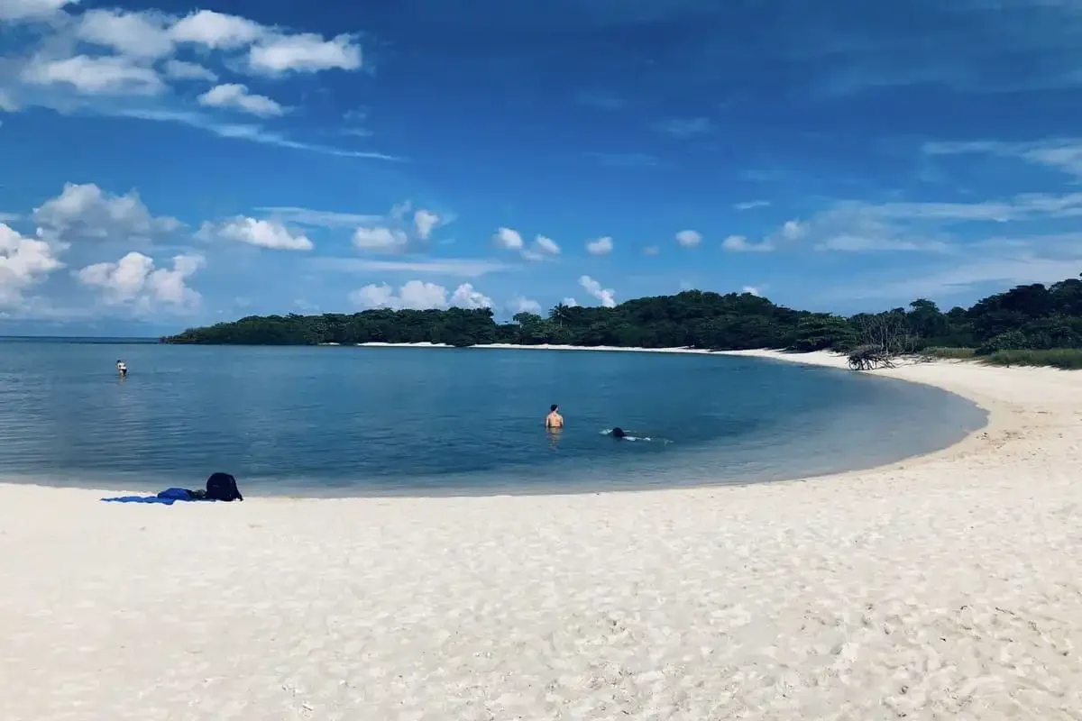 Tranquil lagoon and white sandy beach at Coral Island, part of the Samui Coral & Pig Island Tour.