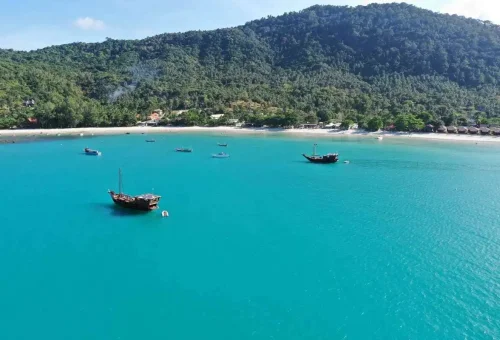 Aerial view of turquoise water and boats anchored near Koh Phangan beach