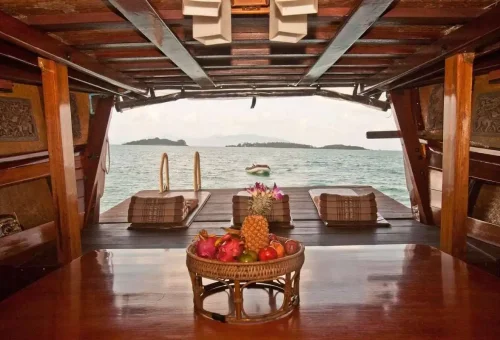 Wooden table with tropical fruits on board the Koh Phangan cruise boat