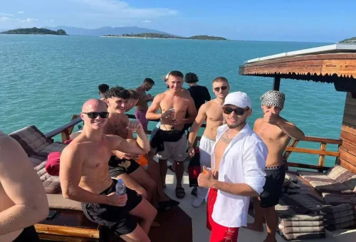 Group of friends enjoying the Koh Phangan Cruise from Samui on a traditional wooden boat