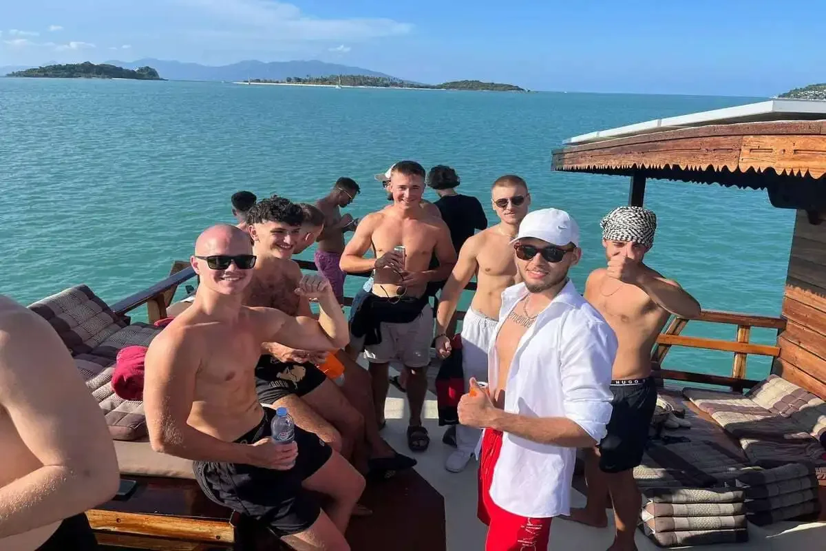Group of friends enjoying the Koh Phangan Cruise from Samui on a traditional wooden boat