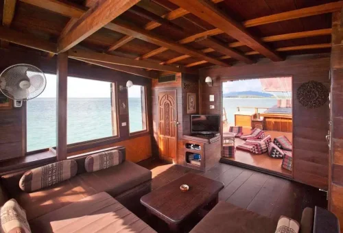 Cozy wooden interior of the Koh Phangan cruise boat with sea view