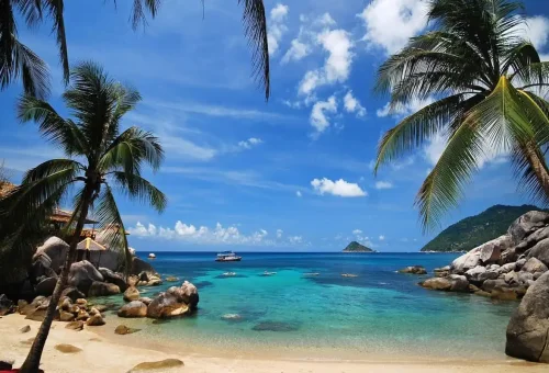 Panoramic view of Koh Phangan coastline with lush hills and calm sea