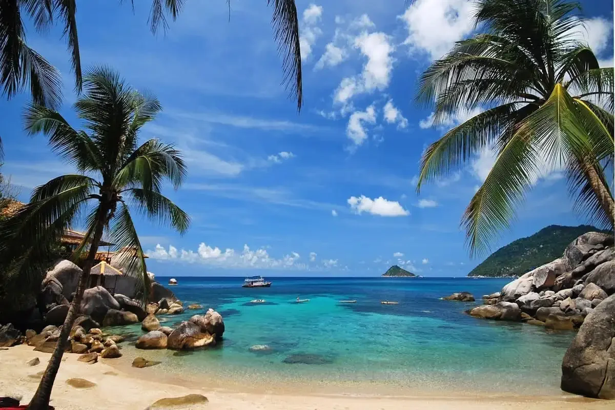 Panoramic view of Koh Phangan coastline with lush hills and calm sea