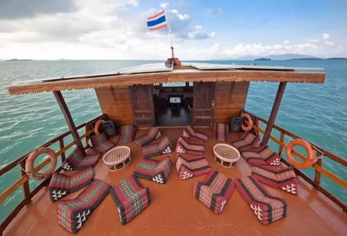 Comfortable Thai triangle cushions on a luxury wooden junk boat