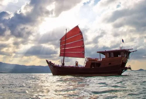 Traditional Thai junk with red sails sailing off Koh Samui