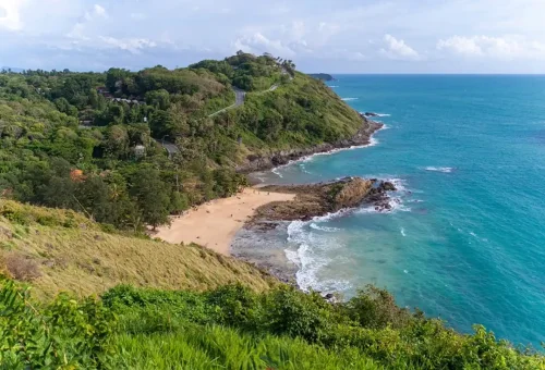 Nui Beach and rocky coastline seen from a high cliff viewpoint in Phuket.