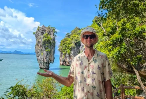 Man posing with James Bond Island viewpoint in Phang Nga Bay during a private speedboat tour with Phuket Travel Store.