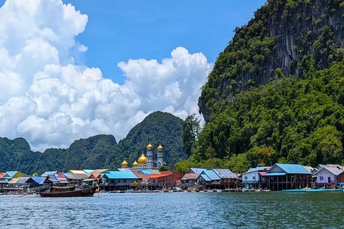 Colorful floating village of Koh Panyee with mosque domes in Phang Nga Bay on a private tour.