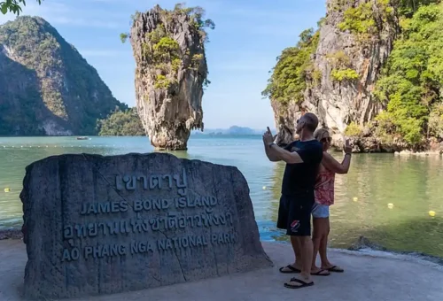 Couple posing at the James Bond Island viewpoint in Ao Phang Nga National Park during a private speedboat tour.