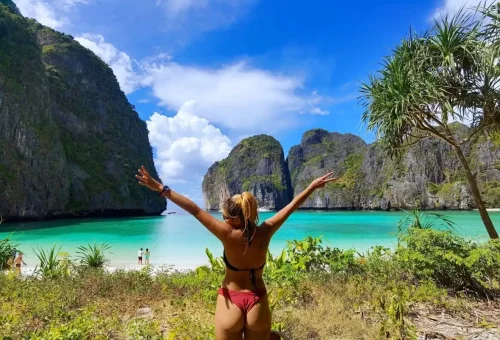 Traveler enjoying the view of Maya Bay’s turquoise lagoon on a Phi Phi private speedboat tour.
