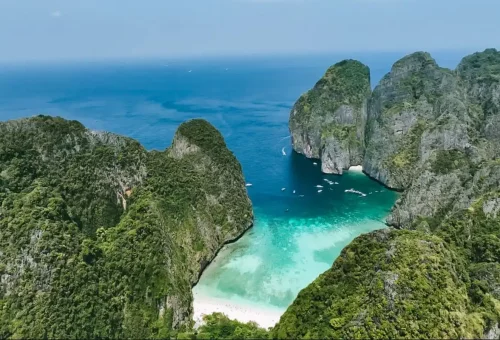 Aerial view of Maya Bay surrounded by limestone cliffs during a Phi Phi private speedboat tour.